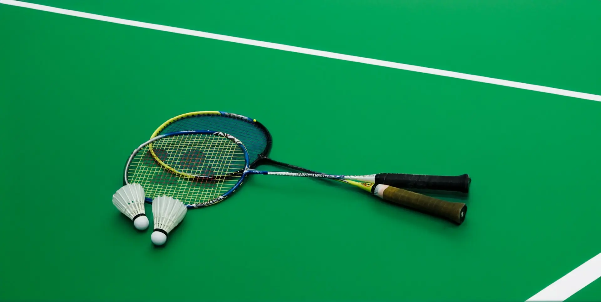 A tennis racket laying on a tennis court